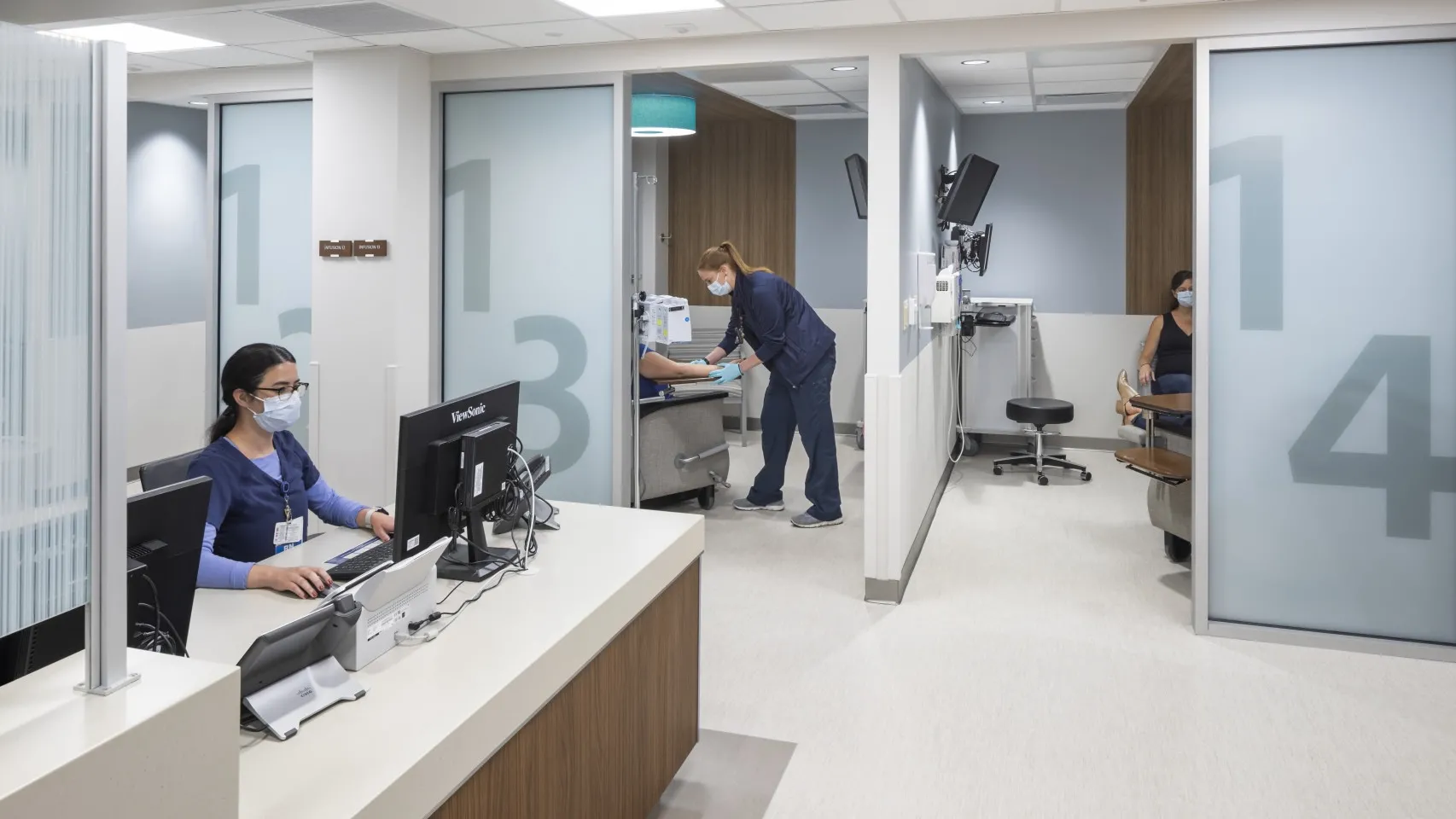 Interior of a nurses station and patient rooms with doors open