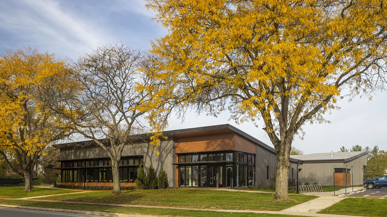 Exterior view of the Directions for Youth and Families Crittenton Community Center surrounded by trees with yellow leaves.