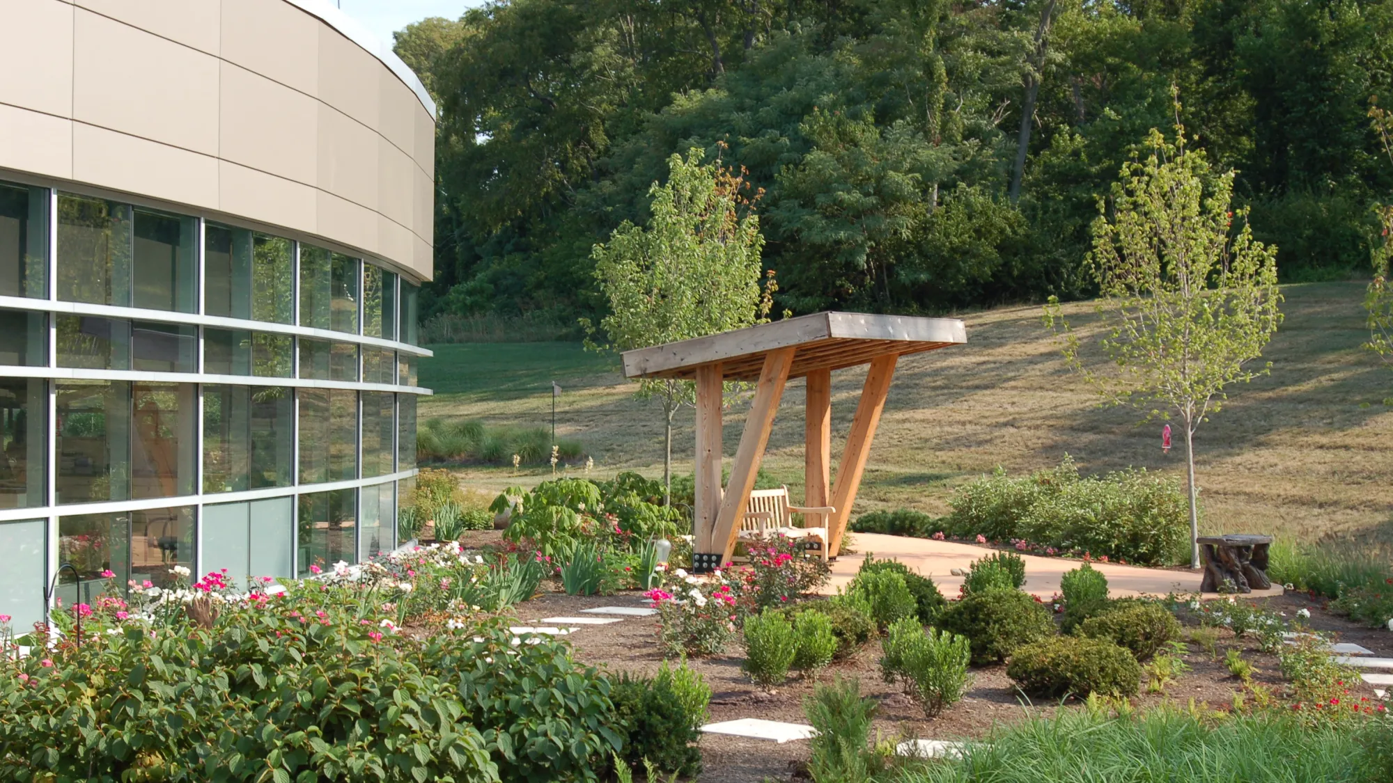 Outside view of the a swing amongst plants and bushes in the Adena Healing Garden.