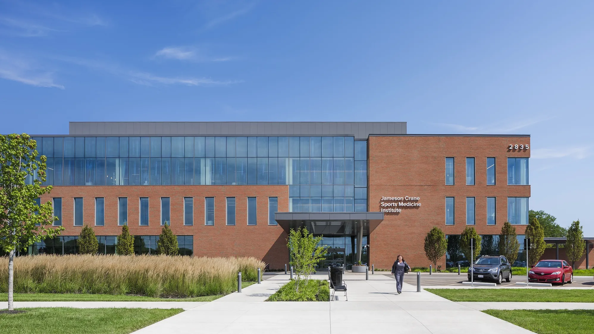 Exterior of Jameson Crane Sports Medicine Institute during the day, a large brick building with large floor to ceiling windows