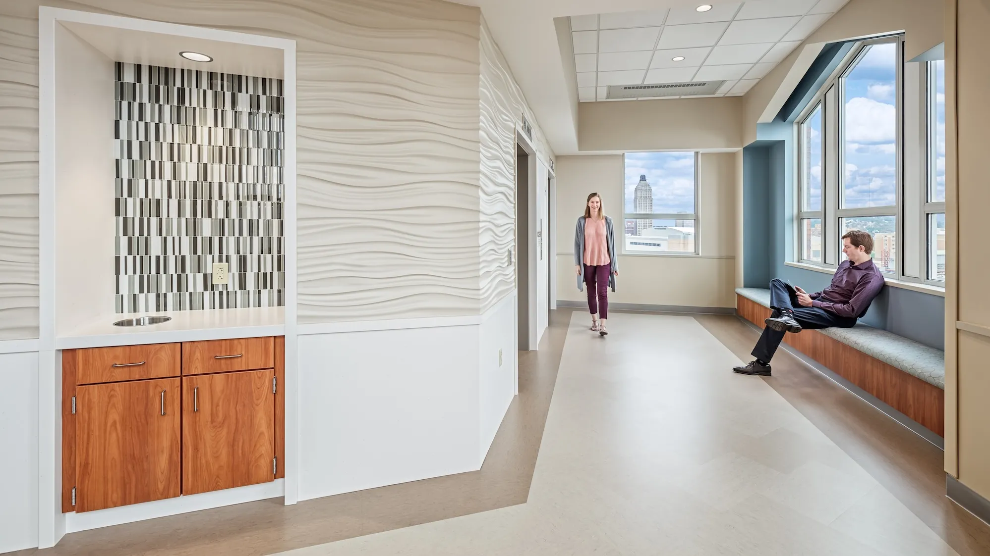 Elevator entrance of the 8th floor of the UPMC Mercy Hospital, featuring wavy textured tan walls and blue accents