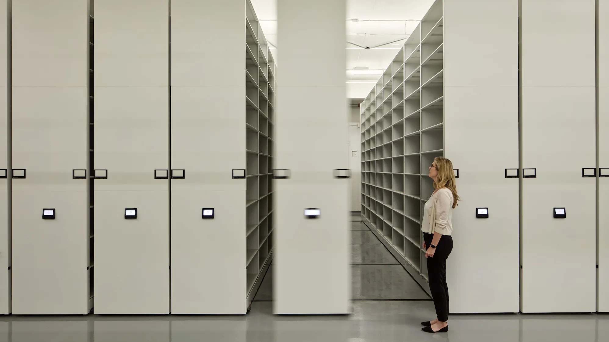 woman in front of shelving units