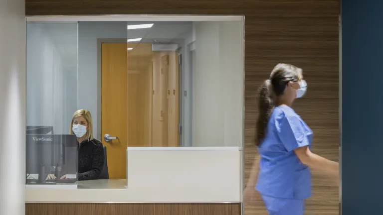 Interior check in desk surrounded by warm wood walls and ceiling