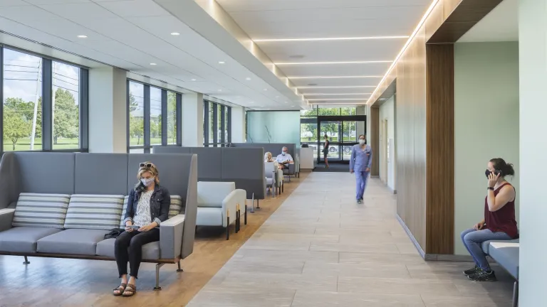 Waiting room lobby of Wyandot Hospital featuring grey cushioned chairs and light blue walls