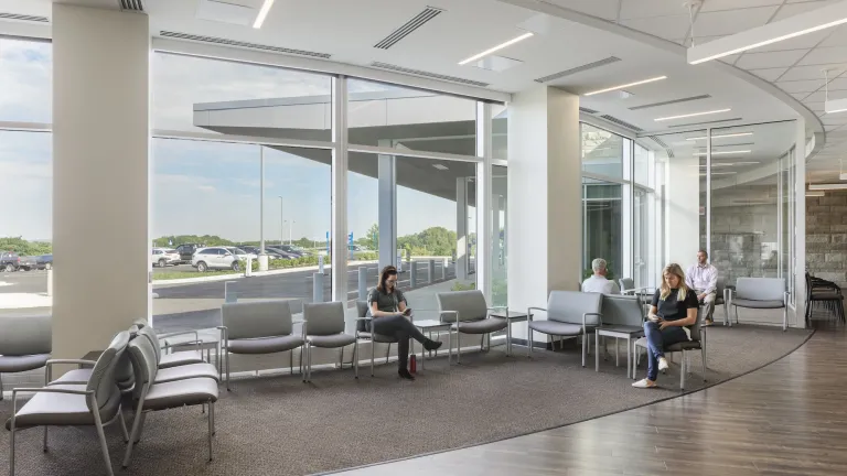 Interior of a modern waiting room in a hospital with floor to ceiling windows