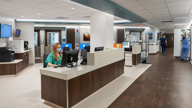 Open and central space featuring a nurse's station with various people working