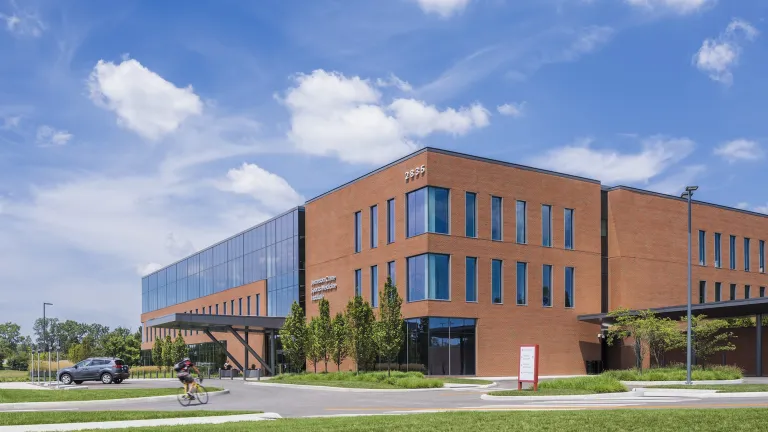 Exterior of Jameson Crane Sports Medicine Institute during the day, a large brick building with large floor to ceiling windows