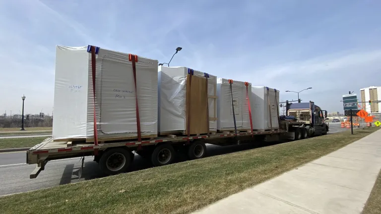 Outdoor during the day of a flatbed truck with patient toilet rooms on the flatbed