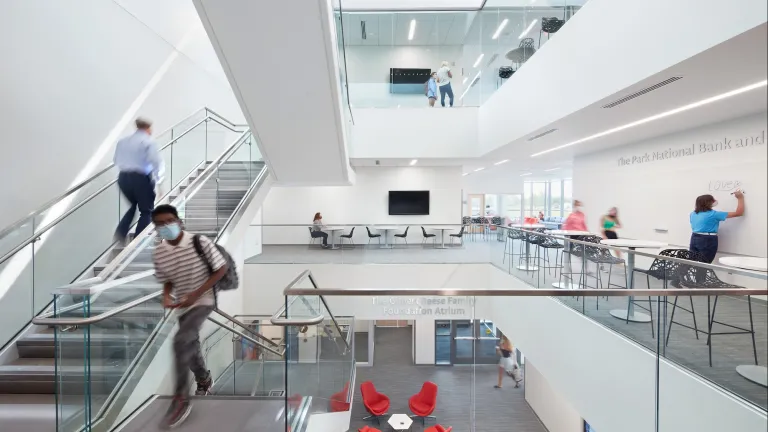 Interior of second floor staircase space of Alford, featuring study tables and large whiteboard