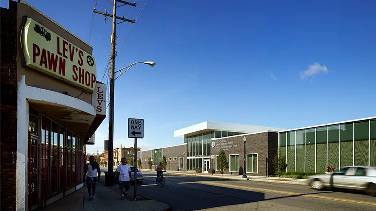 Street view of a pawn shop across the street from a neighborhood health center.