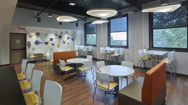 Colorful cafe style seating space featuring yellow and orange accents