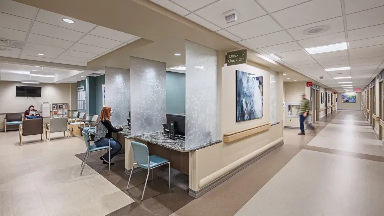 Check in and check out desks within the UPMC with long hallway to the right side and waiting room to the left side