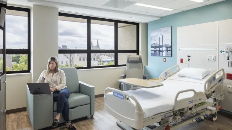 woman sits in chair in inpatient room