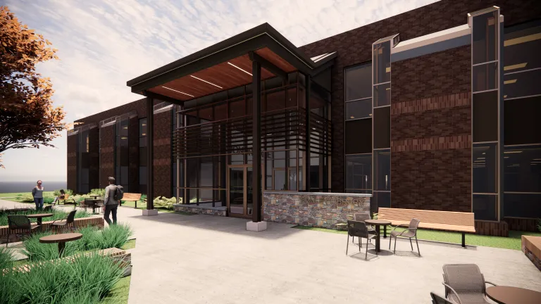 rendering of brown brick building with glass vestibule