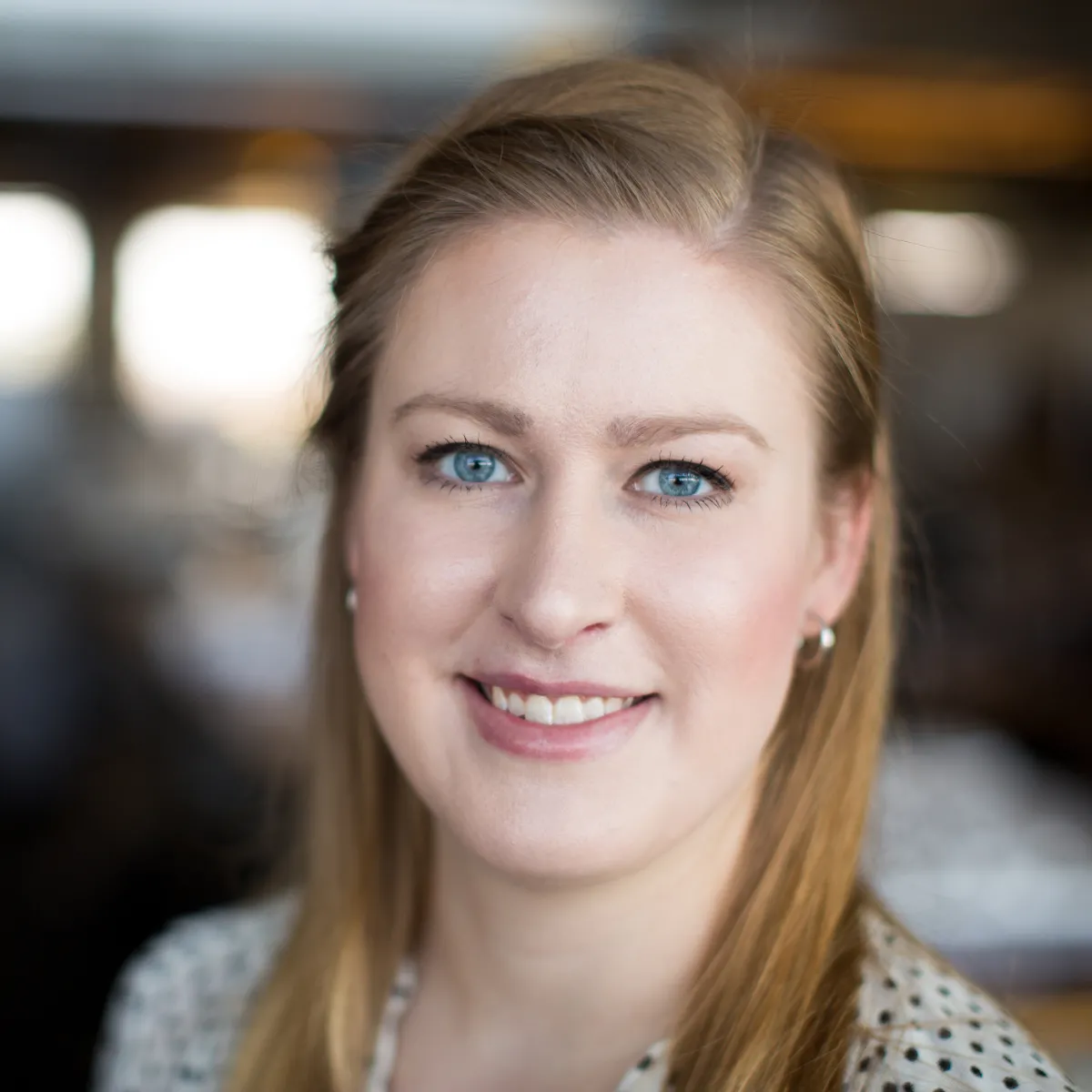 Angela Kolosky smiling, wearing a black and white polka dot blouse