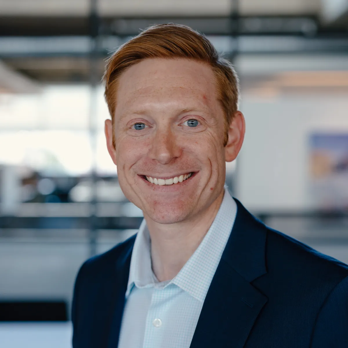 David Sparling smiling, wearing a navy blazer and white shirt