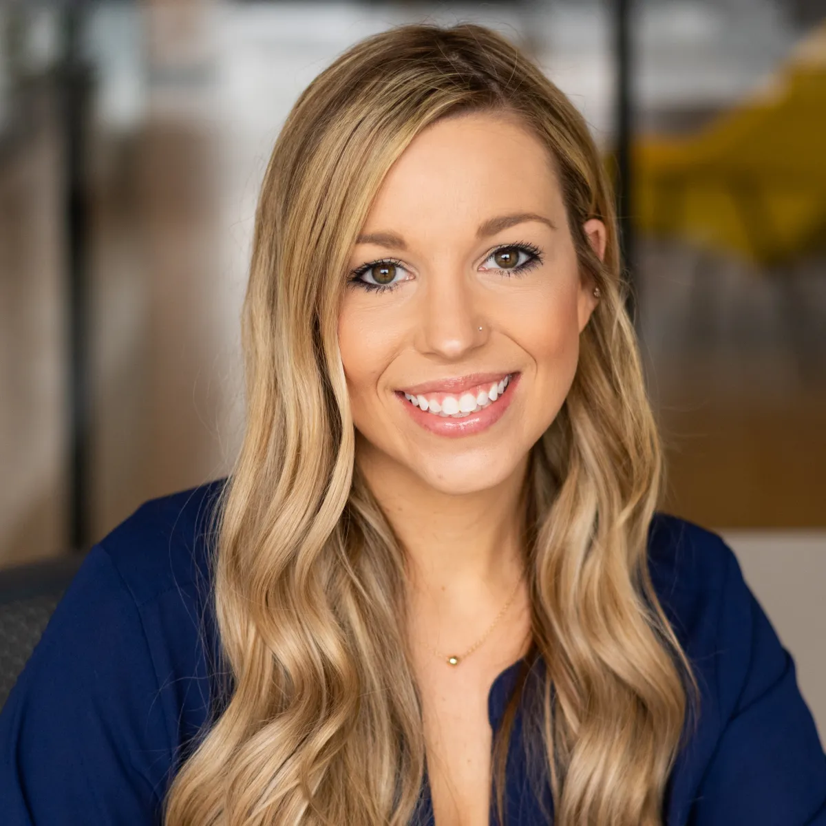 Kaitlyn Voelker smiling, wearing a navy blue blouse