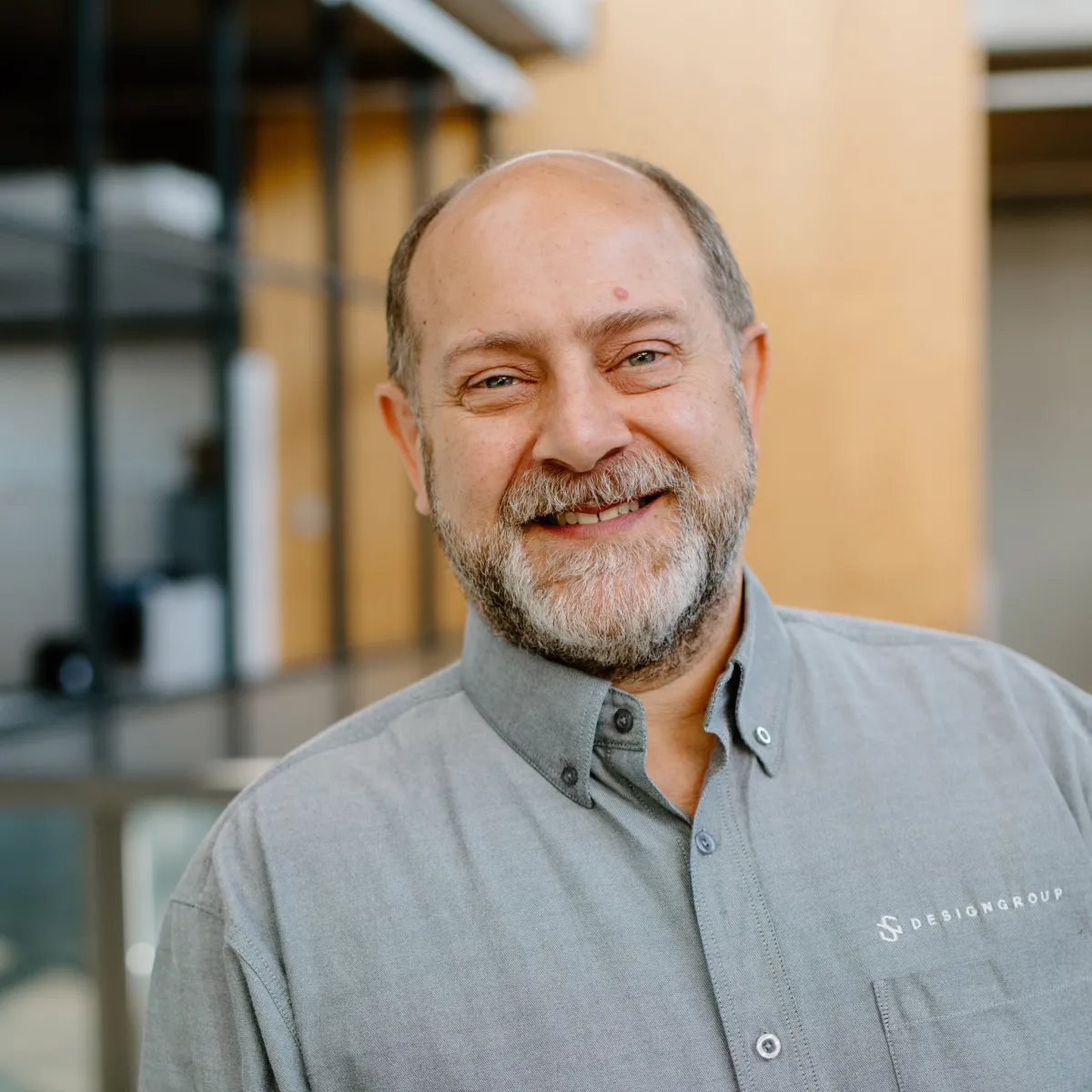 Michael Chervenak smiling, wearing a light gray button down