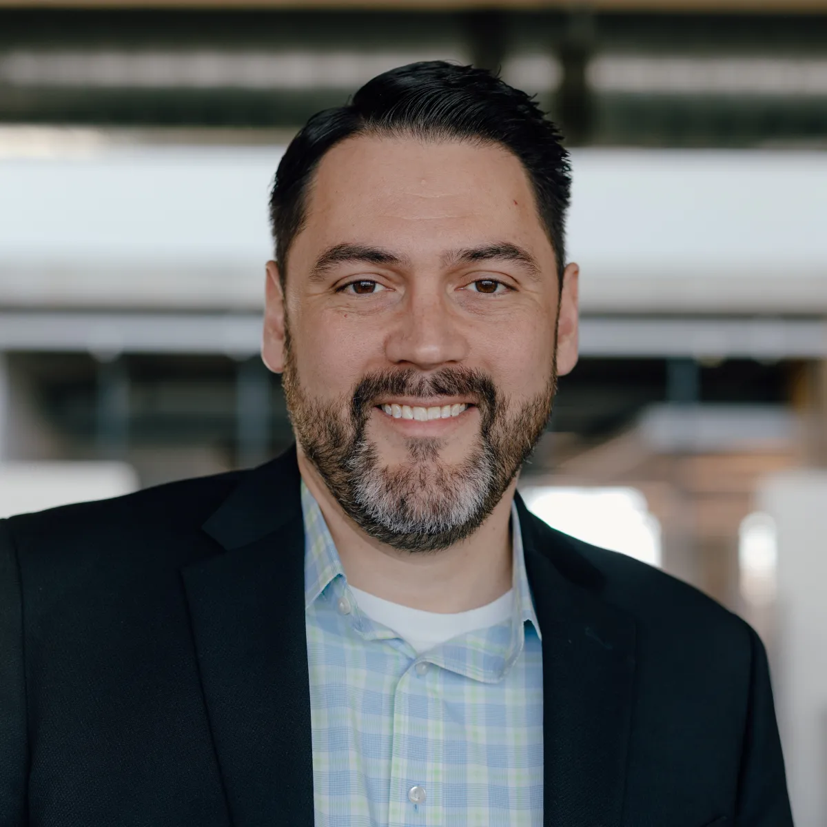 headshot of man with black suit