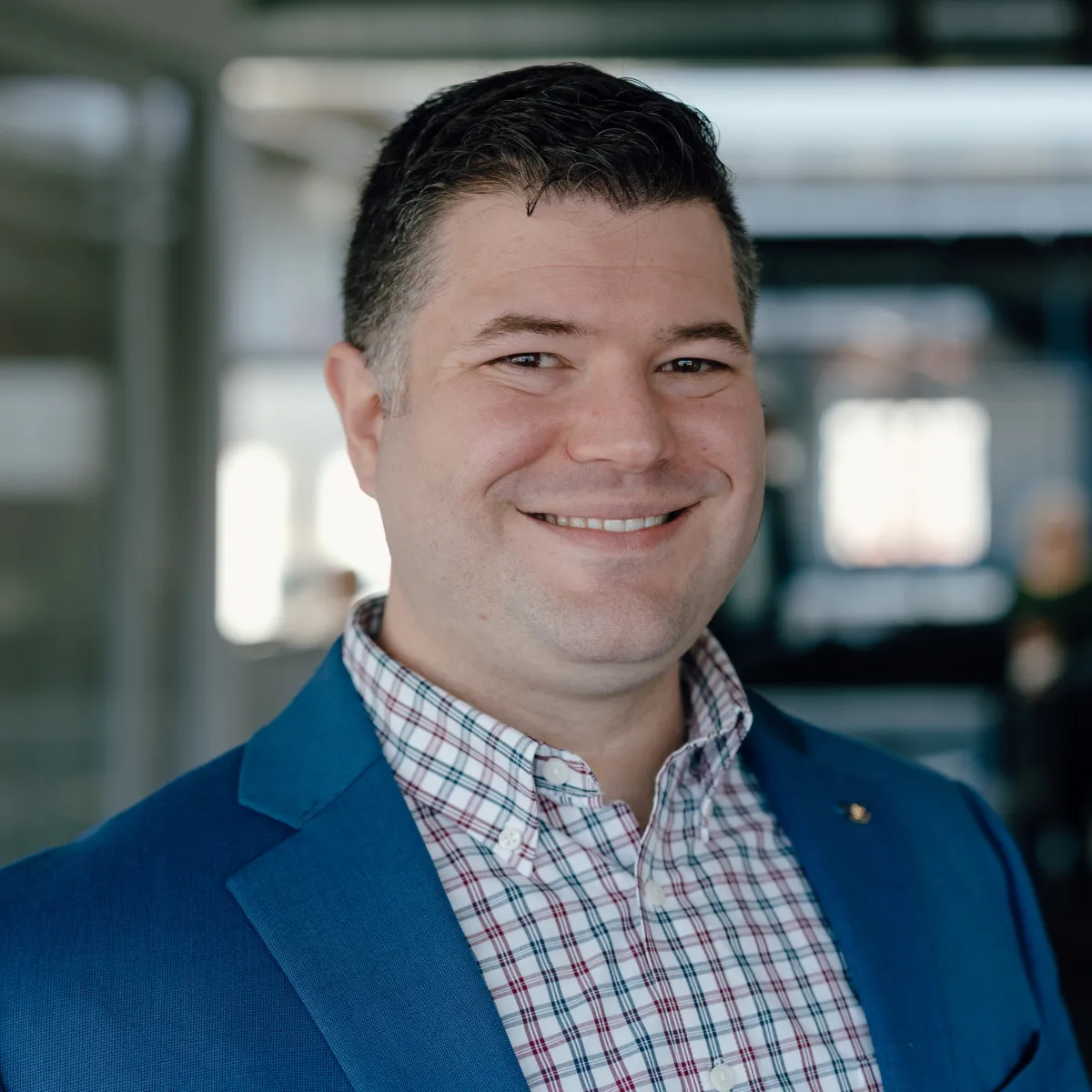 Headshot of man in blue suit