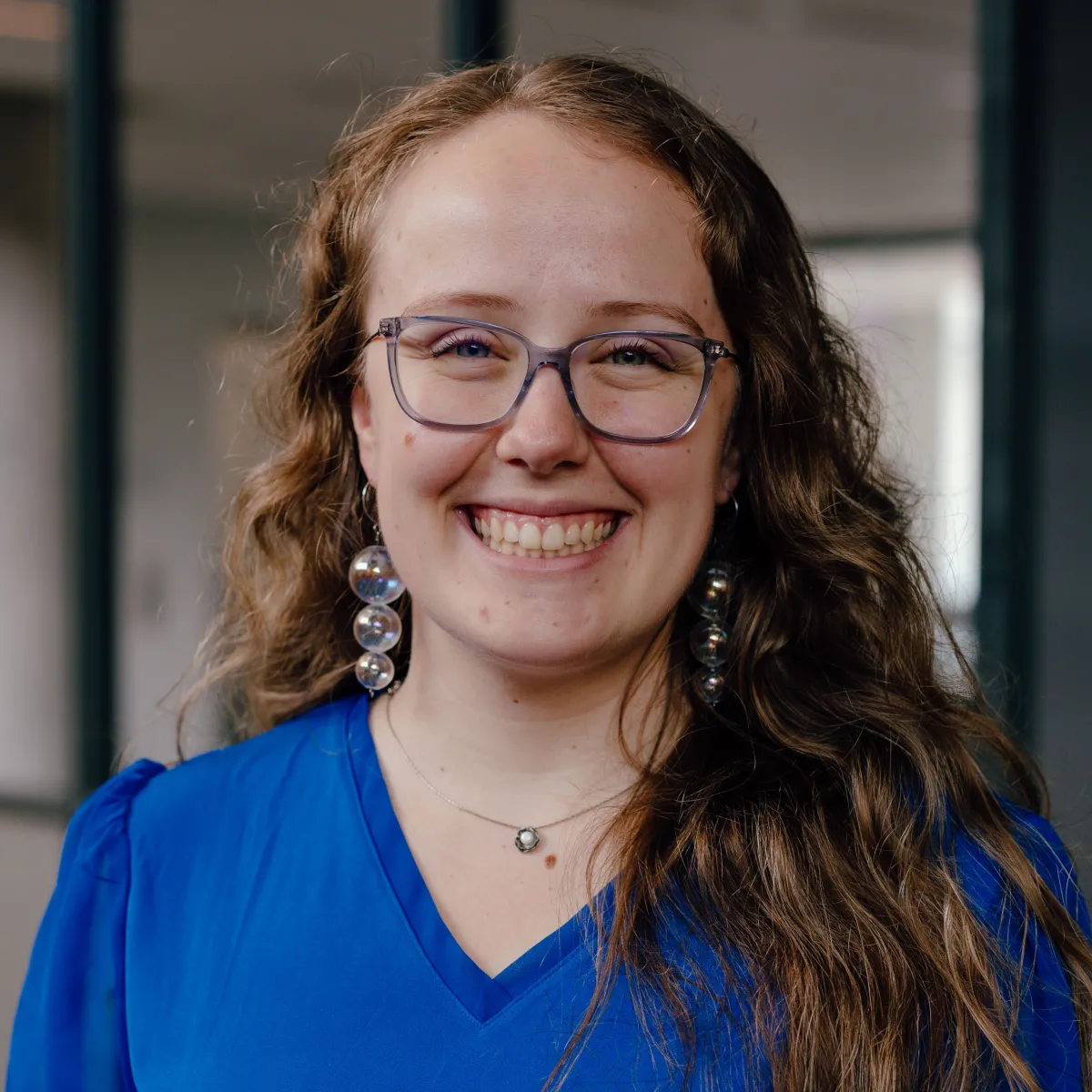 woman with glasses and wavy hair