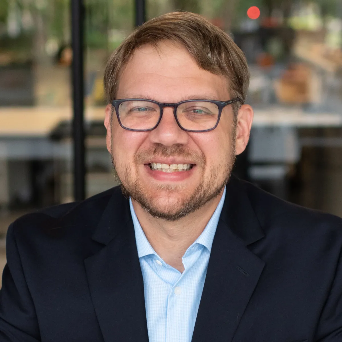 man with glasses and dark jacket