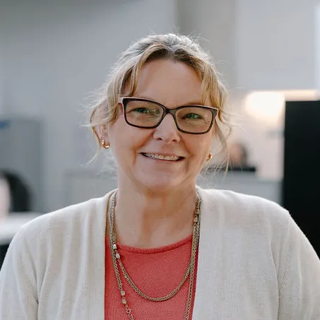 woman with glasses and white cardigan