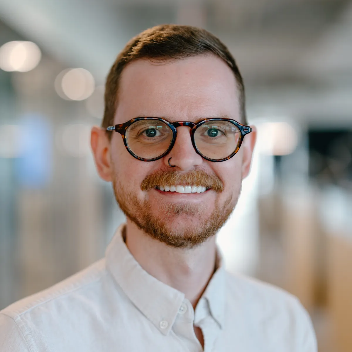 man with glasses wearing white shirt