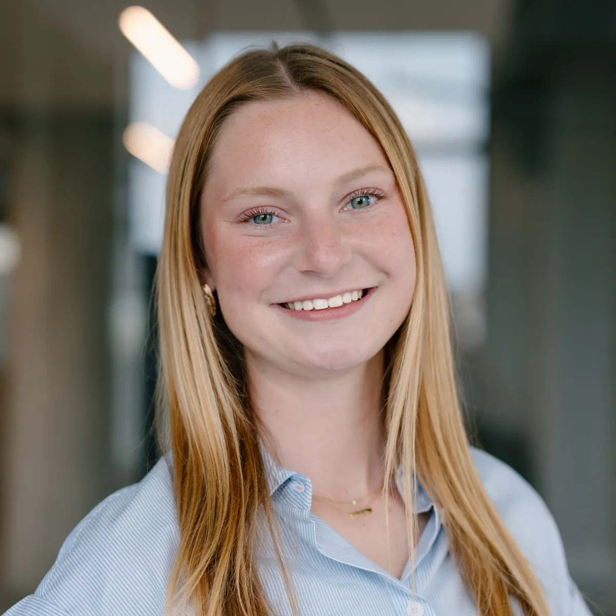 woman with straight long hair wearing light blue shirt