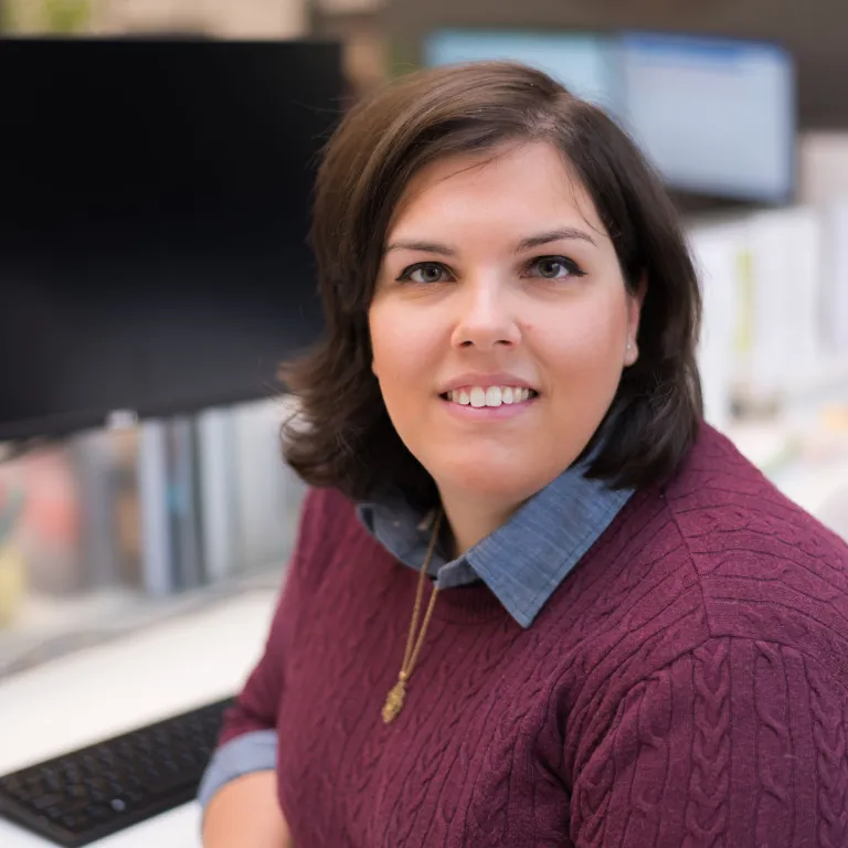 Anastasia Markiw smiling, wearing a maroon sweater