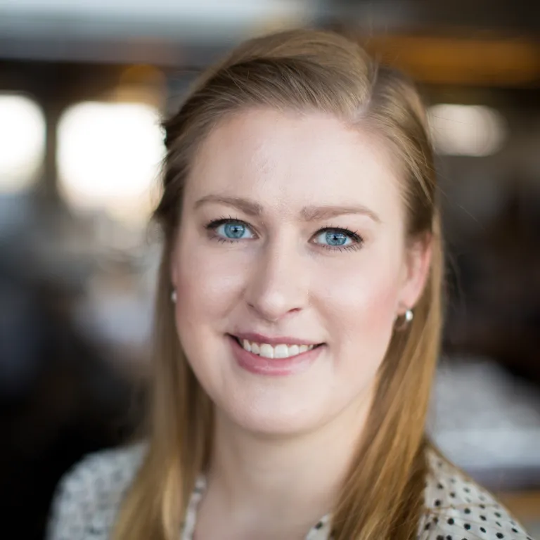 Angela Kolosky smiling, wearing a black and white polka dot blouse