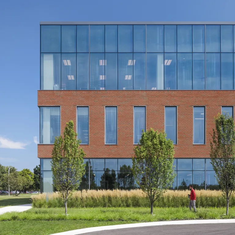 Exterior of Crane building during the day, featuring multiple floors, brick and glass walls