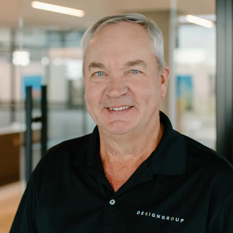 Ken Redman smiling, wearing a black polo shirt