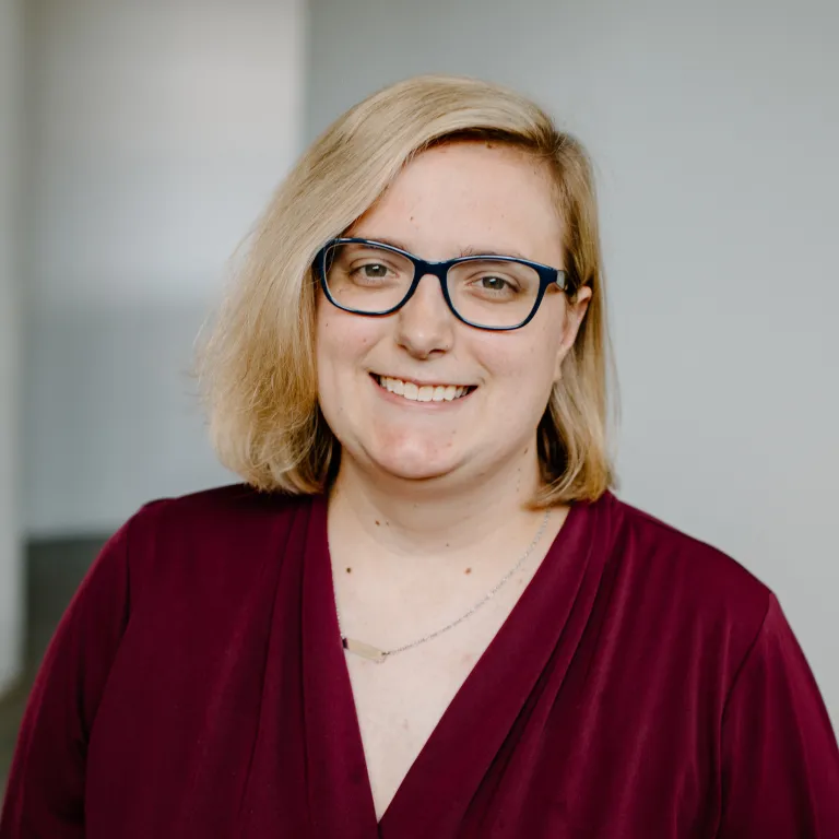 Marissa Andrews smiling, wearing a maroon blouse