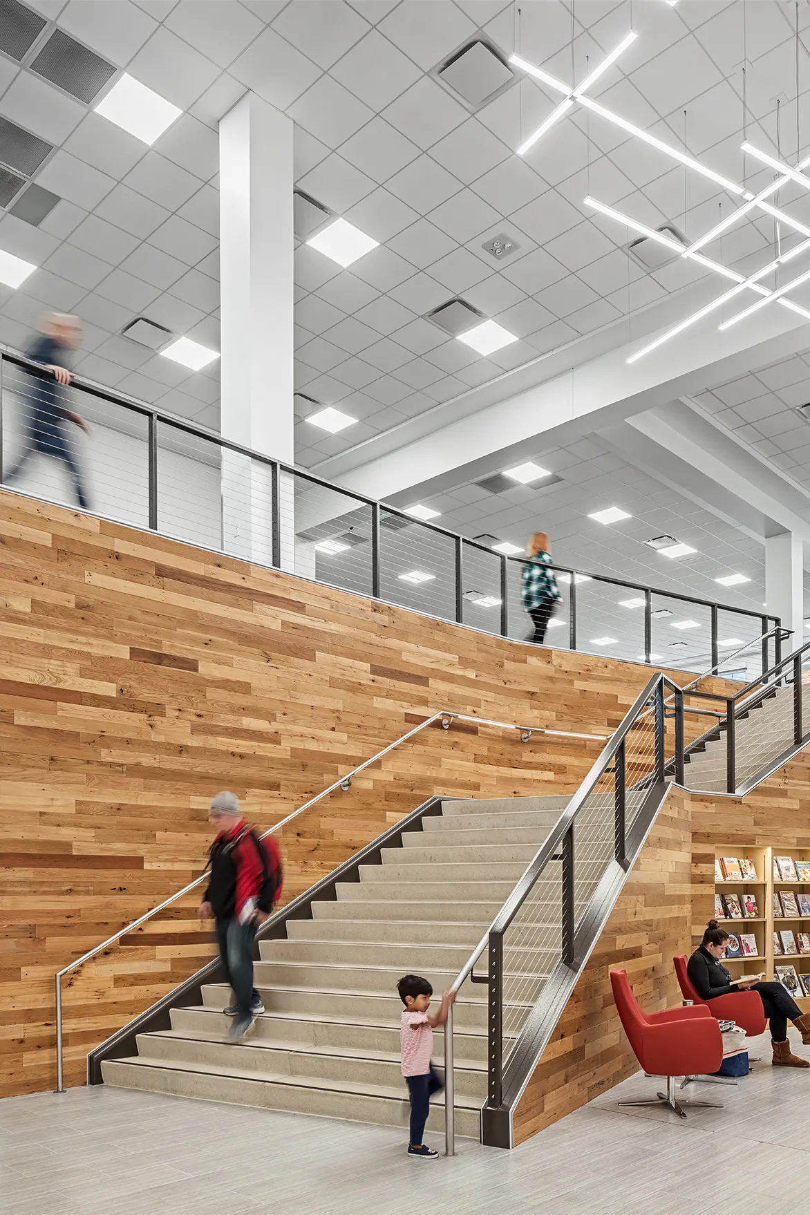 Interior of Hilliard Library featuring stairs with mixed wood paneling