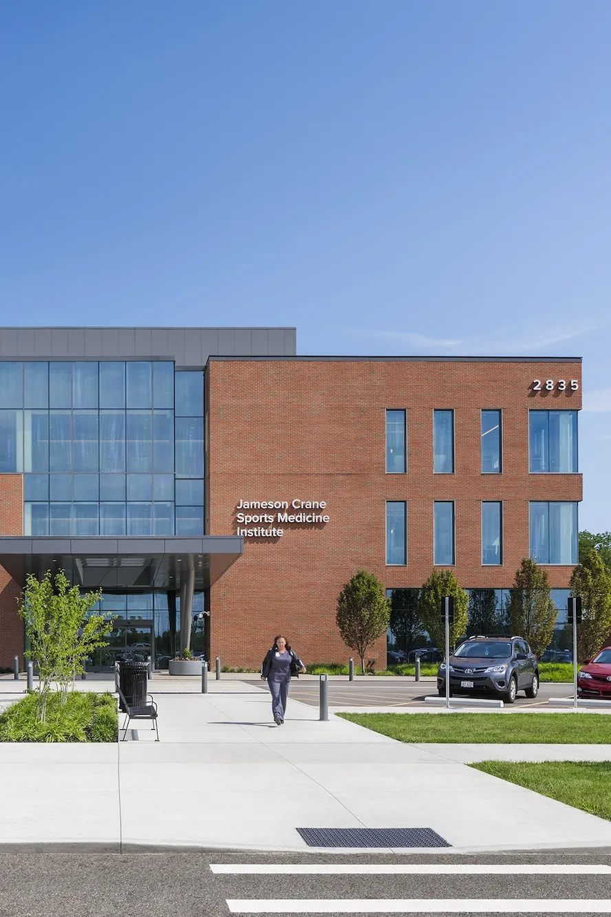 Exterior of Jameson Crane Sports Medicine Institute during the day, a large brick building with large floor to ceiling windows