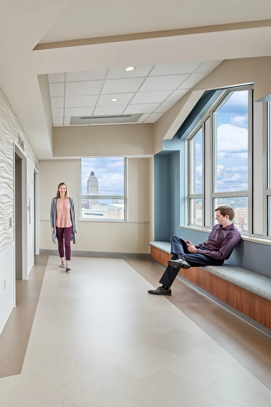 Elevator entrance of the 8th floor of the UPMC Mercy Hospital, featuring wavy textured tan walls and blue accents