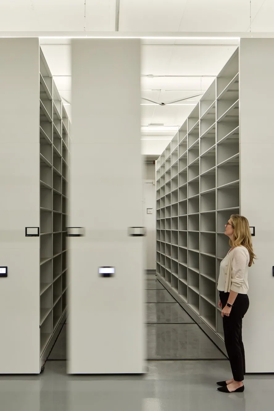 woman in front of shelving units