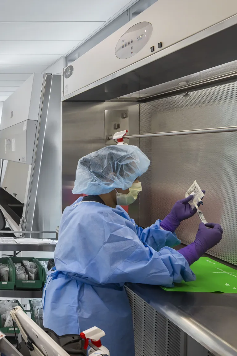 Woman on the right working in a laboratory with test tubes.