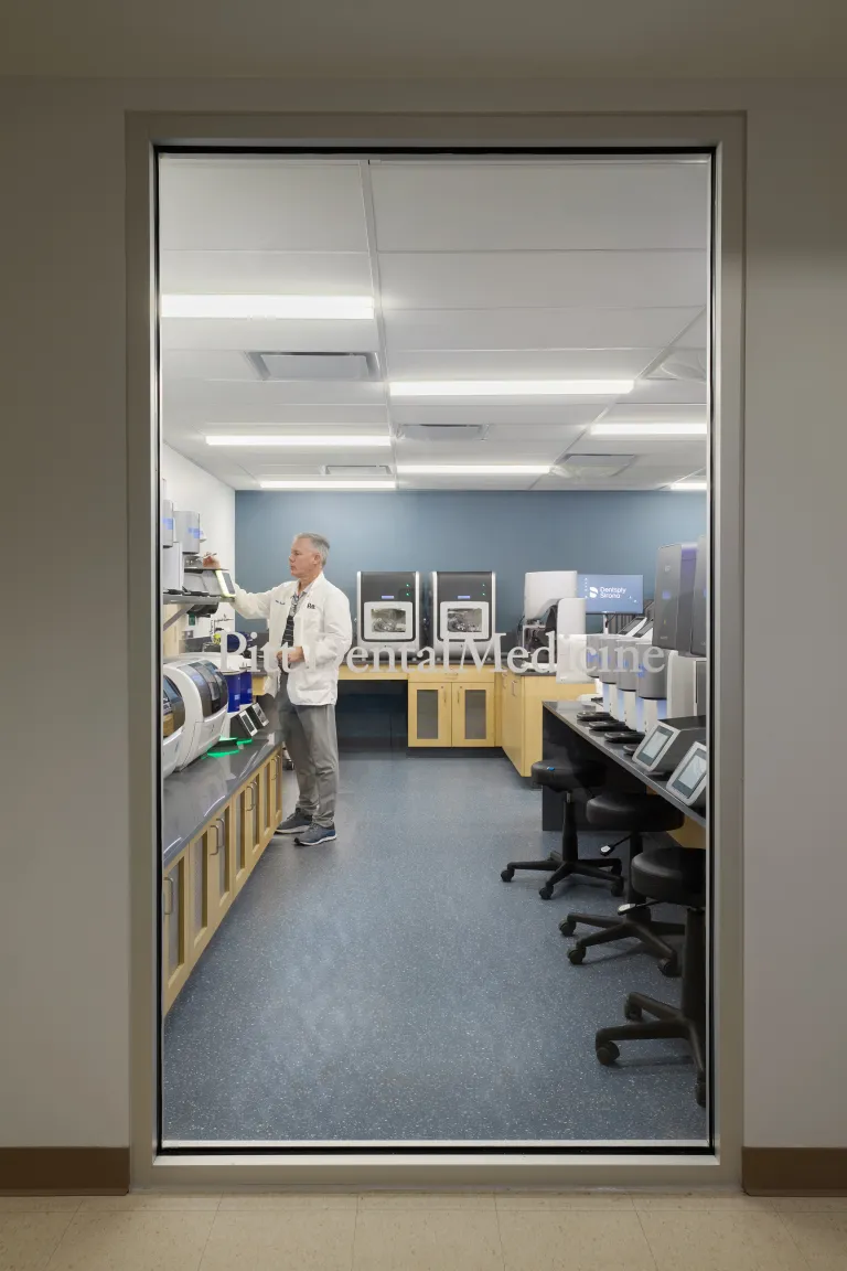 large window looking into room with dental equipment