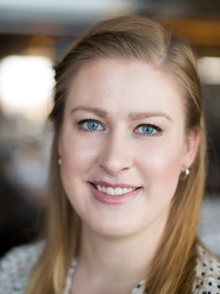 Angela Kolosky smiling, wearing a black and white polka dot blouse