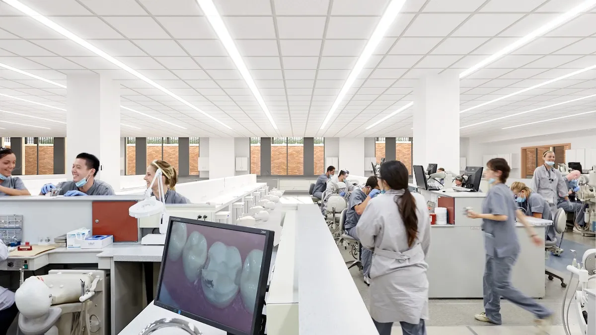 Tables with computers and dental students