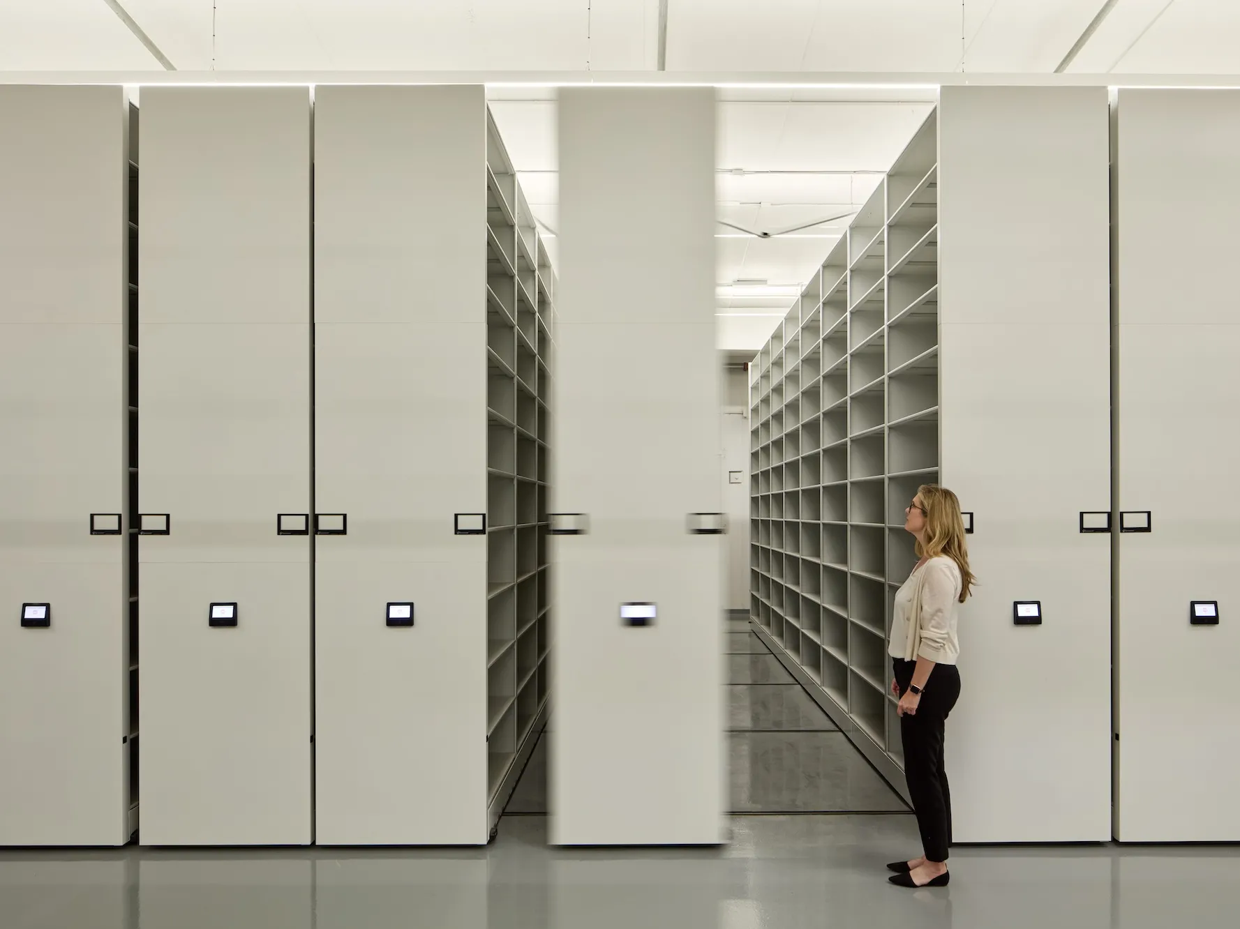 woman in front of shelving units