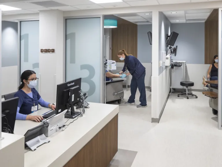 Interior of a nurses station and patient rooms with doors open