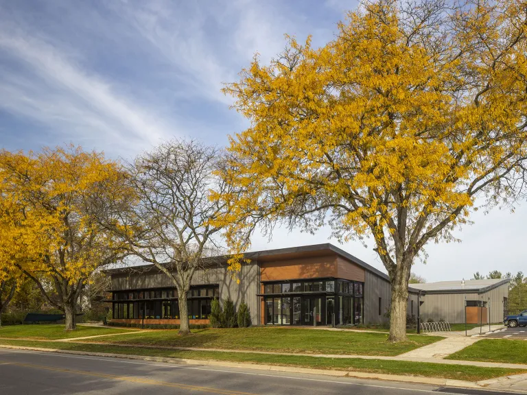 Exterior view of the Directions for Youth and Families Crittenton Community Center surrounded by trees with yellow leaves.