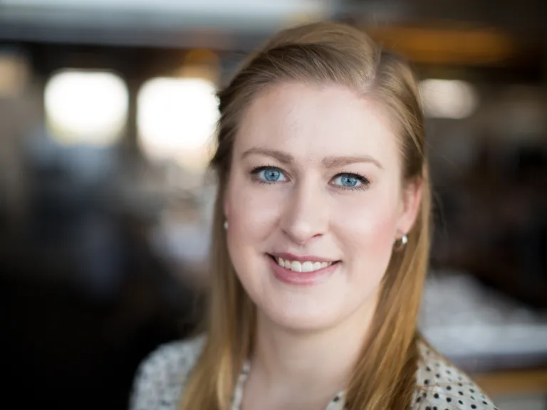 Angela Kolosky smiling, wearing a black and white polka dot blouse