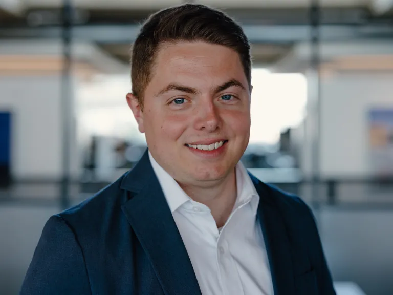 Ben Haywood smiling, wearing blue blazer and white shirt