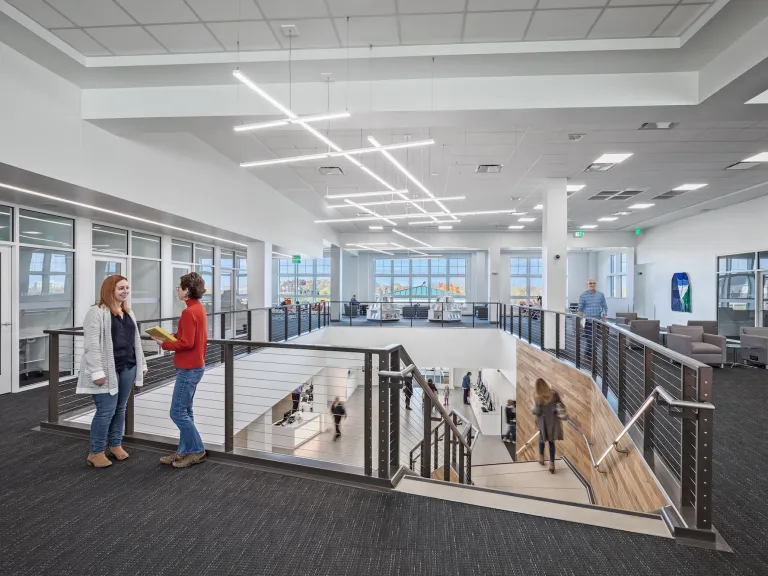 Interior of the second floor of the Hilliard Library, showcasing a wall of private study rooms and quiet spaces