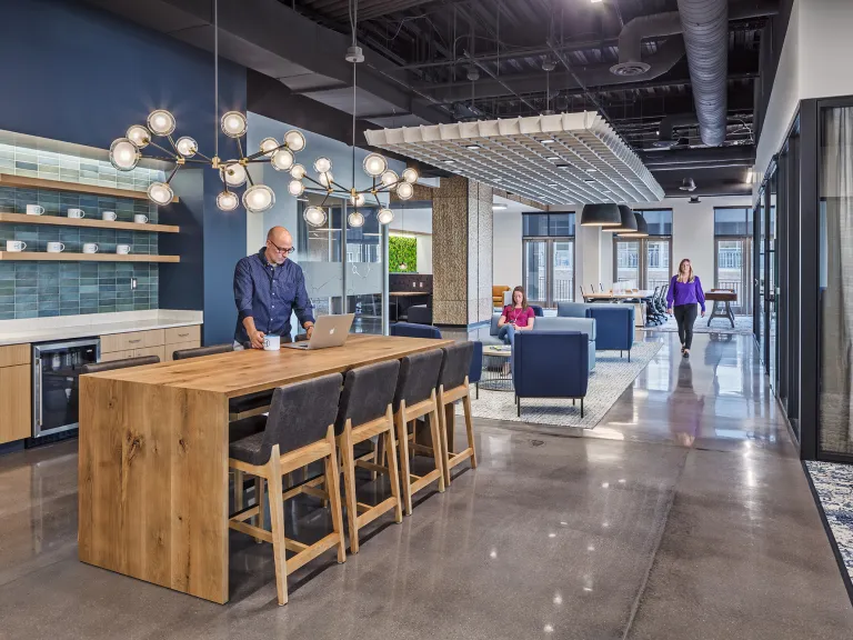 Interior view of the coffee bar space in an industrial style office building.