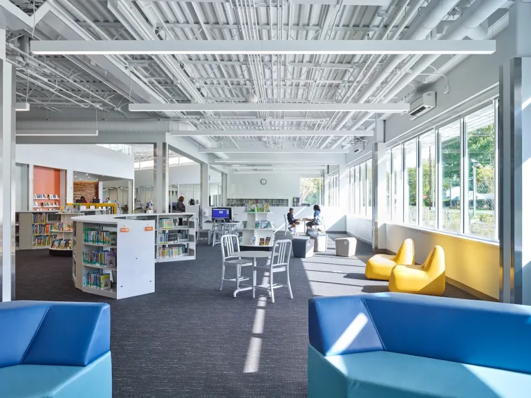 Interior open space within the Northern Lights Columbus Library featuring color blue and yellow couches